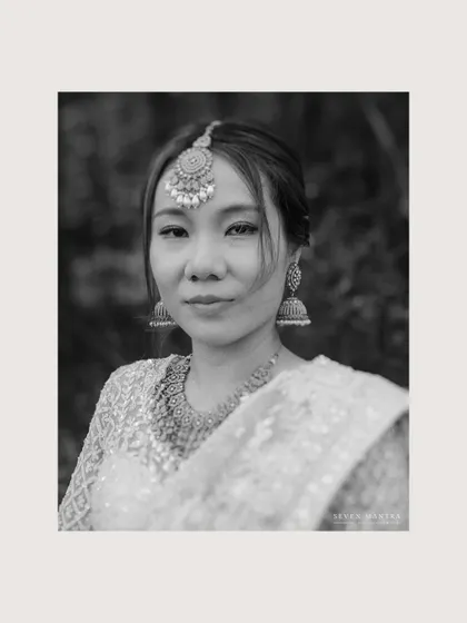 A beautiful black and white portrait of a bride embracing another culture's traditions. Her serene expression and the classic framing make this a timeless shot.