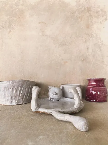 A collection of "misfit" pieces, including a whimsical cat-shaped dish and a textured pot. These happy accidents often become my favorite creations.