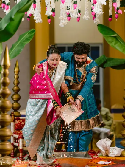 The Laja Homa ritual, captured from a different angle, showing the couple's participation.