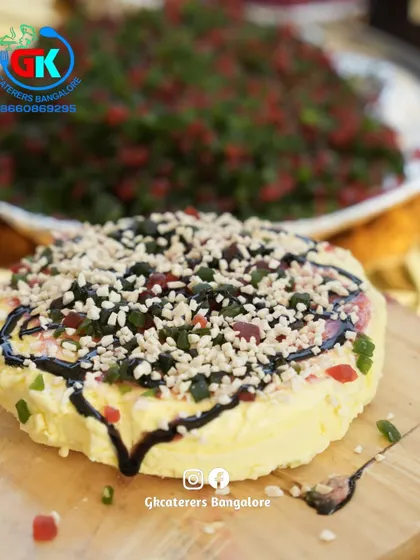 Creative Fruit Cream Dessert: An example of our artistic dessert presentation. This is a beautifully arranged fruit cream dessert, drizzled with chocolate sauce and topped with nuts and tutti frutti.