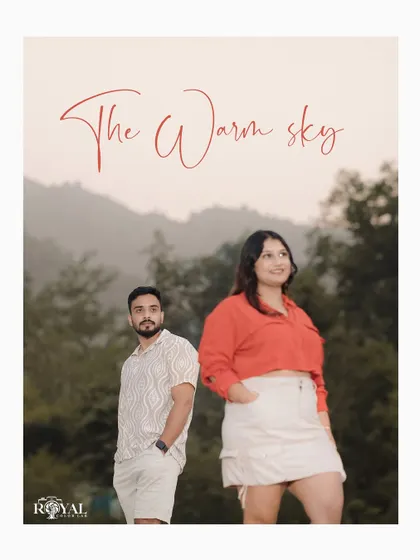 A stylish portrait of an expecting couple against a hazy mountain backdrop. This image showcases a modern, chic approach to outdoor maternity photography.