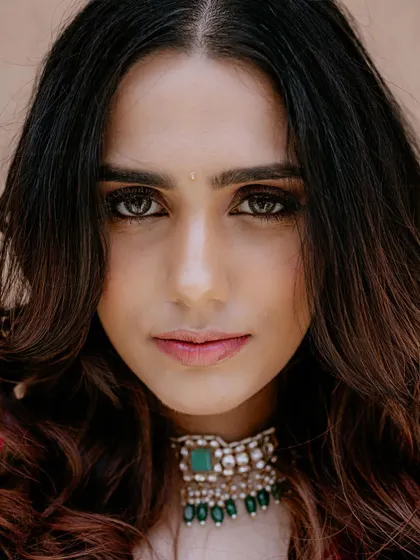 A stunning, direct portrait of the bride. Her confident gaze and flawless makeup are the focus of this captivating close-up shot.