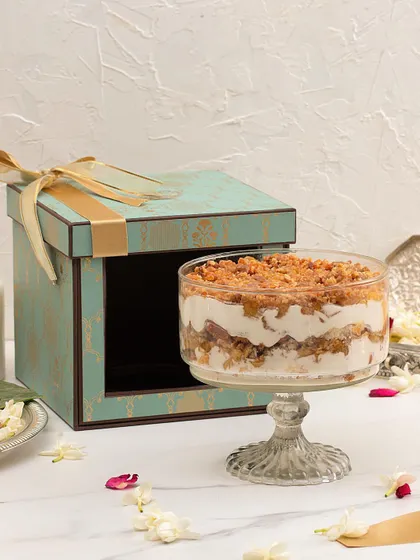 A special creation for the festive season: our Apple Crumble Trifle. This dessert features layers of caramelized apple, light custard, and moist cake with a hint of cinnamon, all presented in our limited edition festive gift box.