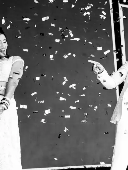A fun black and white photo of the couple's dance performance, with confetti frozen in mid-air.