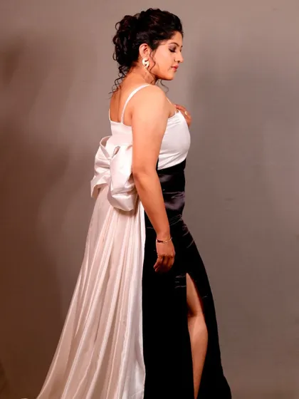 A side profile of the elegant red carpet look, highlighting the hairstyle and gown.