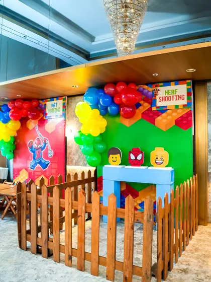 A LEGO and superhero crossover theme for these game booths, featuring a Nerf shooting gallery with fun character targets.