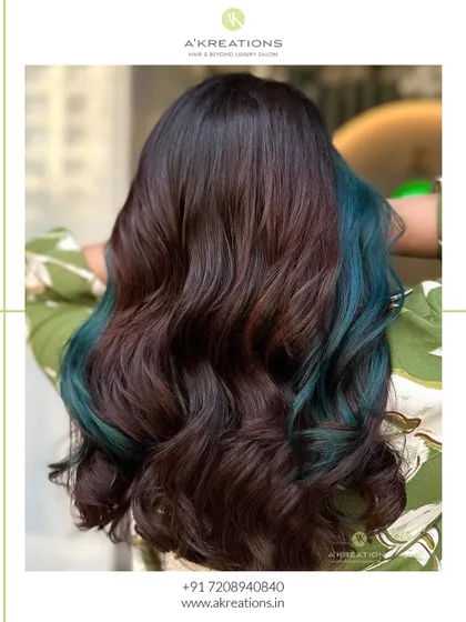 A back view of the peacock green hair, showing the full effect of the color woven through the dark base and styled in waves.