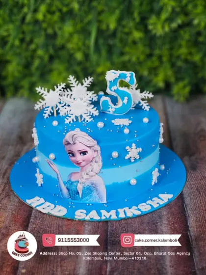 Let it go with this cool Frozen-themed cake for Samiksha's 5th birthday. The edible print of Elsa and snowflake decorations create a perfect winter wonderland.