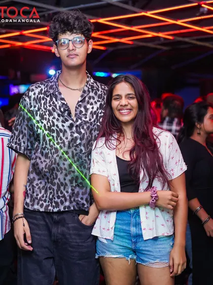 A stylish couple enjoying the Sunday night vibes at Toca.