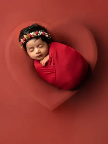 All our love, wrapped in one tiny package. This simple yet powerful shot places a swaddled newborn inside a heart-shaped bowl, symbolizing the immense love that surrounds a new baby.