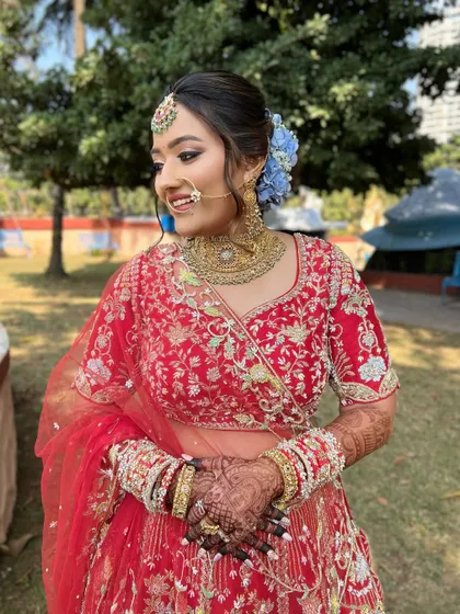 A beautiful portrait of the bride, her makeup enhancing her natural beauty and complementing her gold jewelry.
