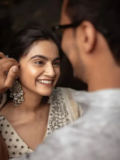 A candid moment of the groom gently touching the bride's hair. It's these small, unscripted gestures that often make the most beautiful pre-wedding photographs.