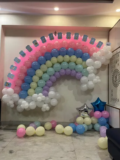 A close-up of the intricate work involved in creating a multi-colored balloon wall.