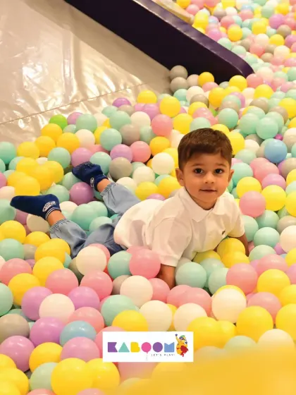 Just chilling in a sea of pastel balls. Sometimes the most fun is just relaxing and taking in the colorful surroundings.