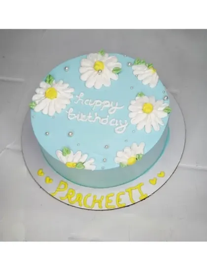 A simple and sweet daisy cake for Pracheeti's birthday. This chocolate vanilla cake is decorated with hand-piped daisies for a fresh and charming look.