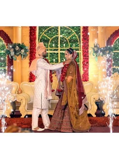 The varmala ceremony on stage, with sparklers adding to the celebration.
