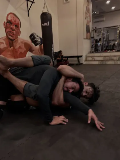 Caught in a tough spot, this grappler works to defend a choke while his opponent maintains tight control. This is where mental toughness is built.