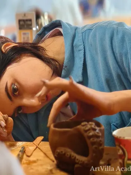 A participant at our Doolally Taproom workshop carefully adds sculptural details to her mug. These events combine creativity with a relaxed, social atmosphere.