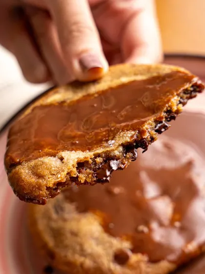 A gooey, chocolate-filled cookie from Bastian. This action shot, showing the cookie being broken in half, is designed to trigger an immediate craving.