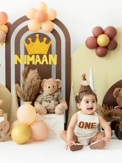 A handsome little prince on his first birthday. The earthy tones, teddy bears, and a crown create a warm and regal theme for this milestone shoot.
