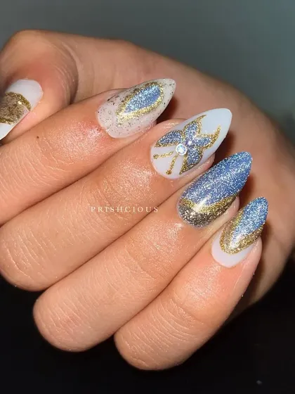 A close-up of the glittery butterfly nail art. The details are all created with different shades of glitter polish for maximum sparkle.