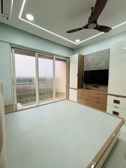 This view highlights the large window, which provides ample natural light. The furniture placement is designed to maximize this brightness.