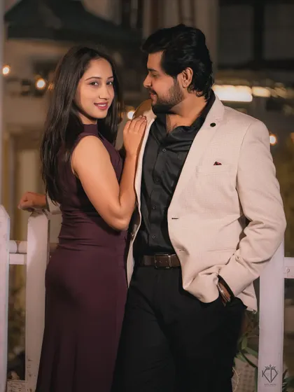 A classic and elegant evening portrait of the couple. The soft lighting from the background adds a touch of glamour and sophistication.