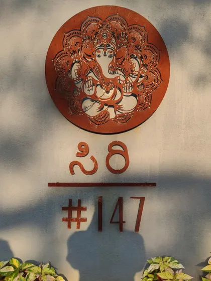The custom-designed nameplate for the Siri residence, crafted from corten steel and featuring a beautiful Ganesha motif for an auspicious welcome.