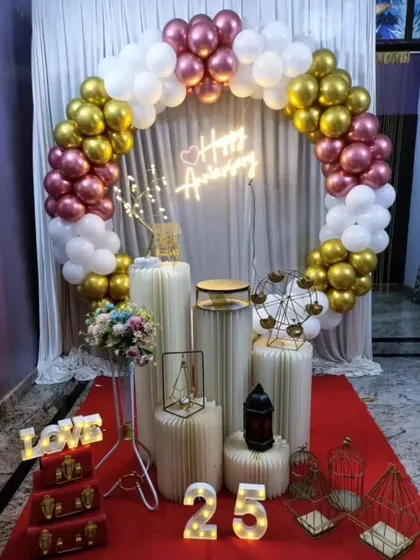 Celebrating 25 years together with this elegant anniversary setup. It features a red carpet, a circular balloon arch, and light-up numbers to mark the special milestone.