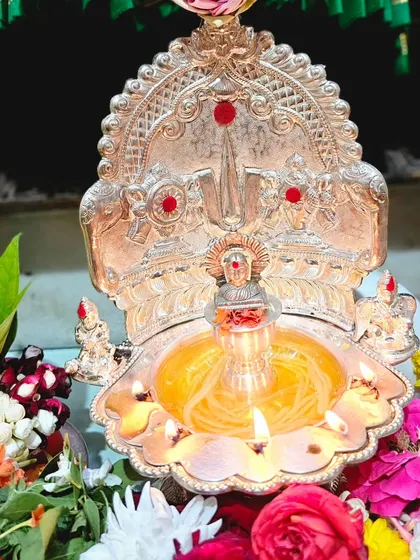 The sacred lamp, or deepa, is essential to the pooja. This is a silver lamp prepared for the Varamahalakshmi festival, ready to be lit to invoke divine light.