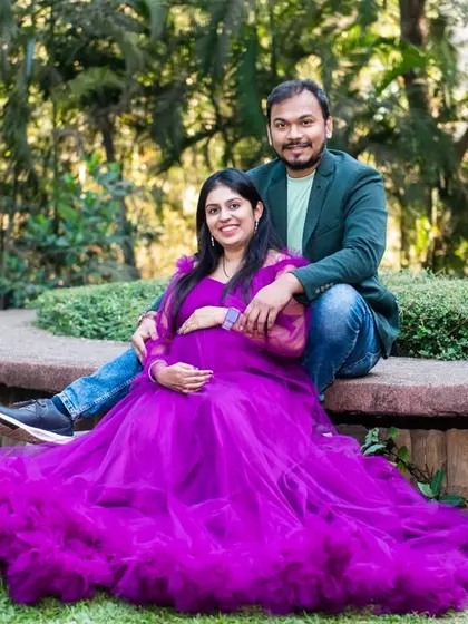 A stunning portrait featuring a magnificent ruffled purple gown. This photo shows how a bold dress choice can create a truly unforgettable and artistic maternity image.