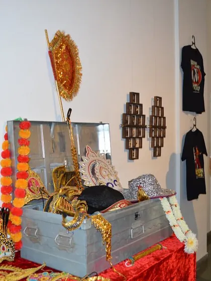The Consul General looking at the collection of costumes and props.