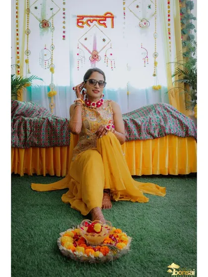 A stylish shot of the bride in sunglasses, adding a cool and modern vibe to her Haldi look.