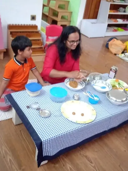 A mother and son share a smile during a cooking session. Our parent participation days are filled with joy, collaboration, and the sharing of delicious, healthy food.