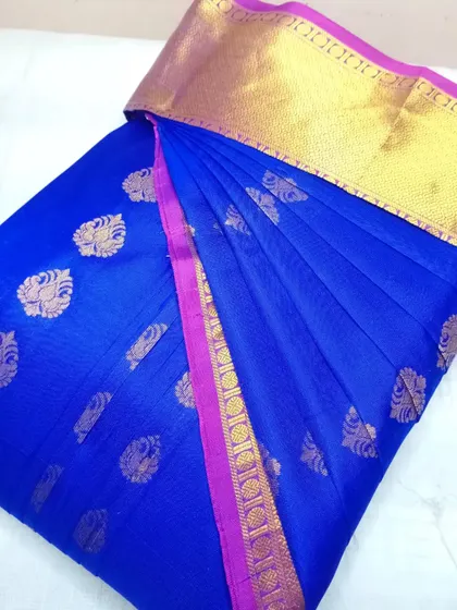 A classic royal blue saree with a pink and gold border. It's been pre-pleated and is ready to be worn for any special occasion.