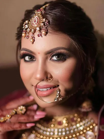A captivating close-up of the bride's makeup. Her beautiful eyes are enhanced with liner and lashes, and the skin has a radiant, airbrushed finish that is perfect for wedding photography.