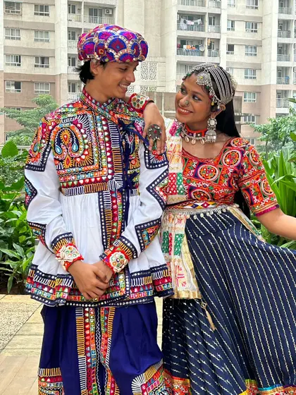 A great example of a full men's outfit, featuring a white kediyu with colorful embroidery, blue dhoti pants, and a matching pagdi.