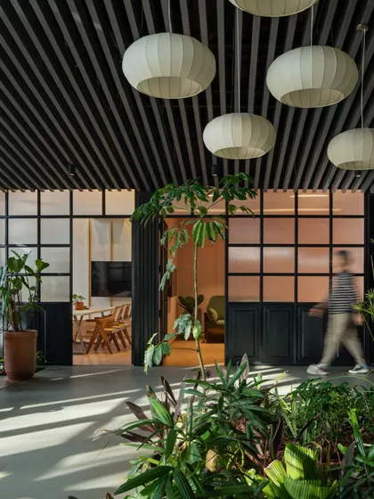 In this sales lounge, I used biophilic design to create a tranquil and engaging environment. An indoor garden bed acts as a natural divider, while frosted glass partitions and soft, lantern-like lighting create a sense of calm movement and connection to nature, even within a corporate setting.