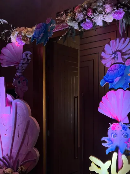 For Jivana and Janya's first birthday, we created another enchanting under-the-sea world, featuring marquee letters, iridescent backdrops, and a soft play area for the tiniest guests.