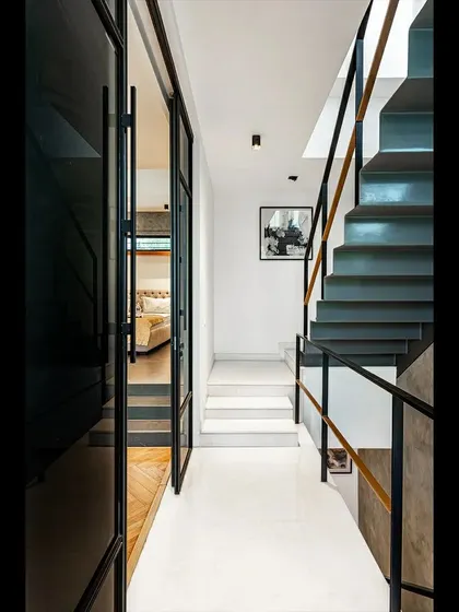 The circulation path in the SOL House combines white marble steps with a folded steel staircase. This juxtaposition of materials and forms is a recurring theme in our work, creating moments of architectural interest.