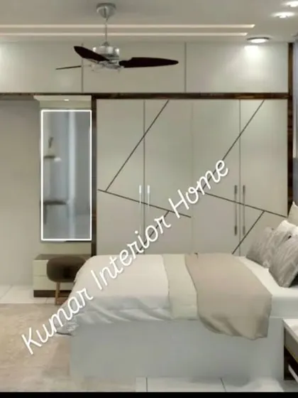 A master bedroom with a white and wood theme, featuring a wardrobe with geometric patterns, a built-in dressing table, and a floating study desk.
