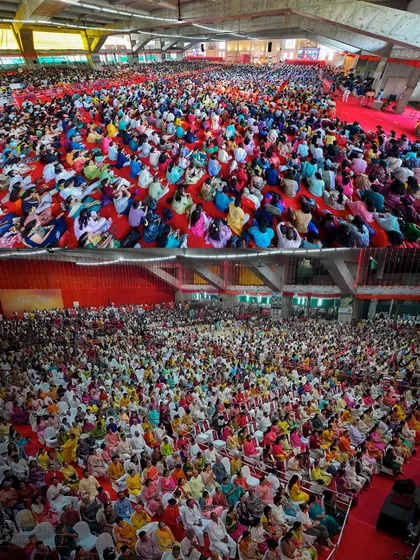 A panoramic view of the thousands of people gathered for the Maha Rudra Homa during Navratri. The sheer number of participants creates an ocean of devotion and collective energy.
