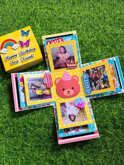 The full reveal of the best friend birthday explosion box. You can see how the photos are framed with cute stickers and messages, creating a joyful and personalized gift.