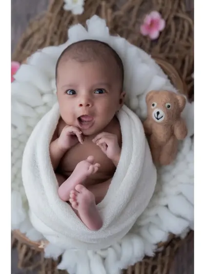 Hello, world! Not all magical moments happen during sleep. I love capturing the bright, curious eyes and expressive faces of awake newborns. This little one, nestled in a soft basket, seems ready to take on the world.