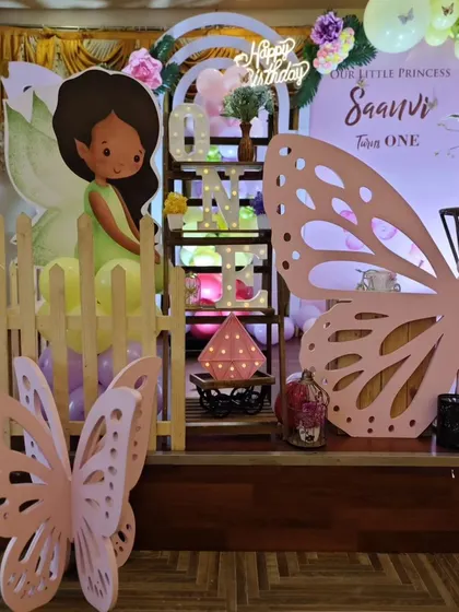 A decorative corner of the stage with a fairy cutout and butterfly wing prop's.