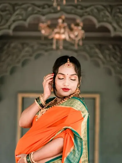 An elegant solo portrait of the mother-to-be during her traditional maternity shoot. Her graceful pose and the ornate background highlight the beauty of this special time.
