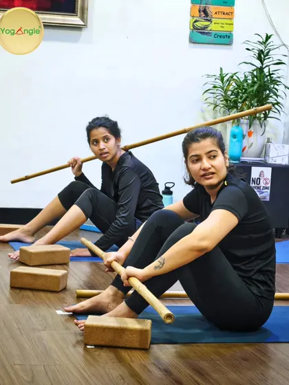 Our Stick Yoga classes are both challenging and fun. Here, students use bamboo sticks to assist with posture and alignment, often leading to moments of intense focus mixed with lighthearted discovery.