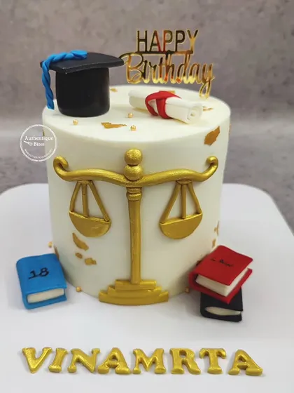 A sophisticated cake for a law student or lawyer. This design features the scales of justice, a graduation cap, a diploma, and law books.