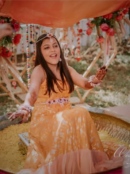 The bride enjoying the 'phoolon ki holi' during her Haldi ceremony.