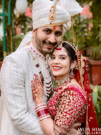 An intimate and happy portrait. The couple embraces, sharing a genuine smile that showcases their deep connection and the joy of the moment.